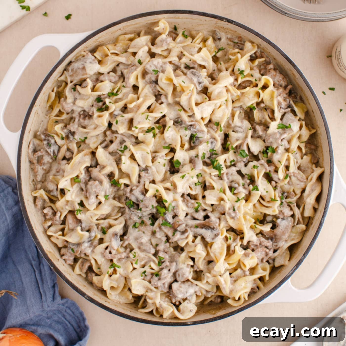 Creamy Ground Beef Stroganoff 11 Close-up of a skillet filled with finished Ground Beef Stroganoff, garnished with parsley and ready to serve.