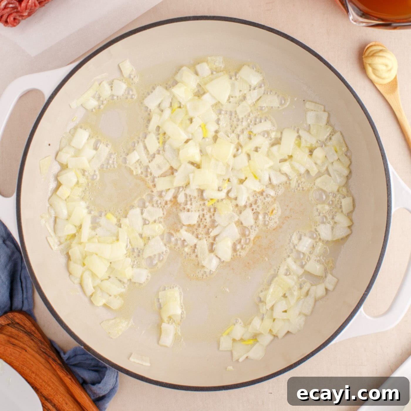 Creamy Ground Beef Stroganoff 5 Sauteing chopped onions in butter in a large skillet until translucent.