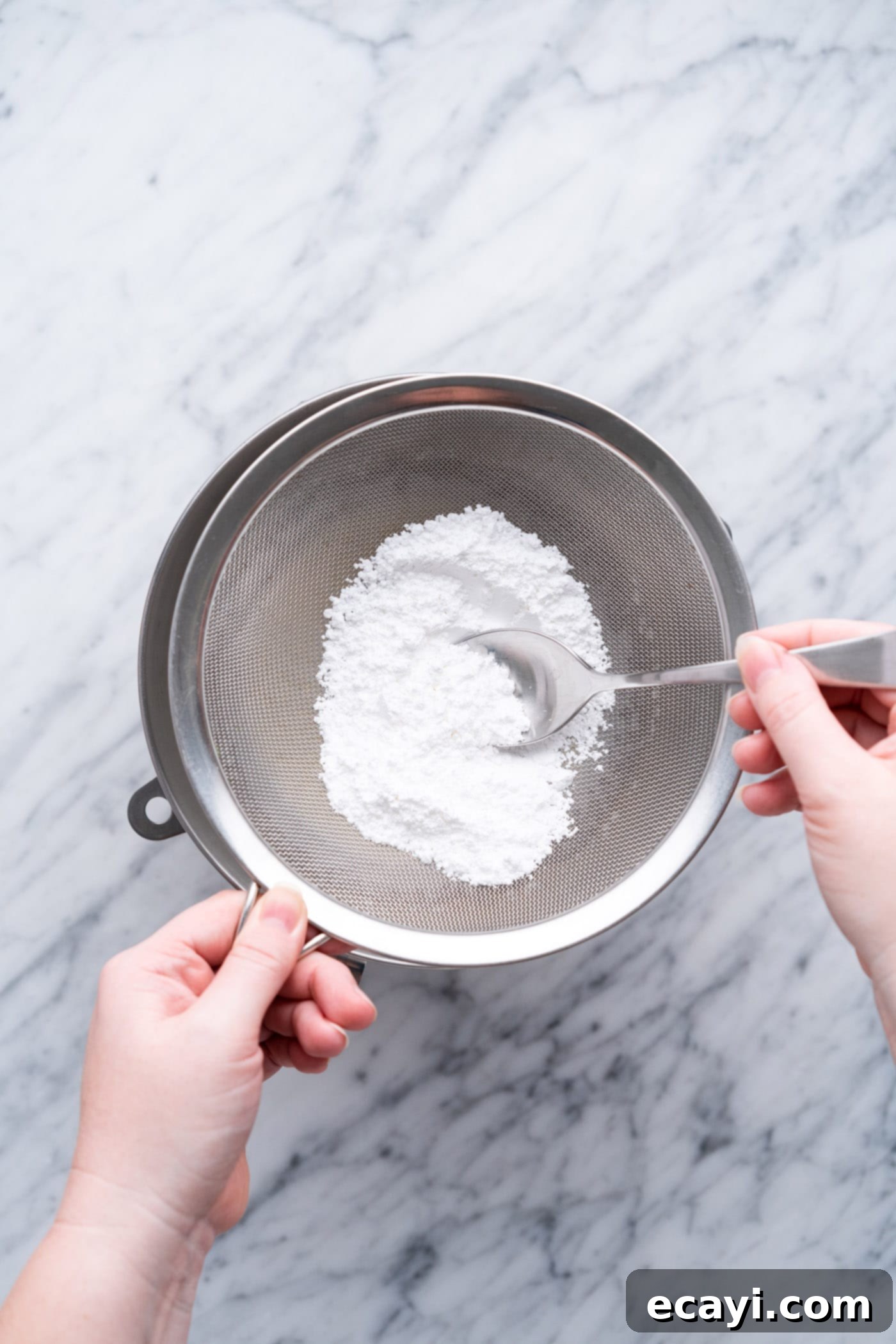 Steadfast Whipped Cream 8 adding sifted powdered sugar to bowl