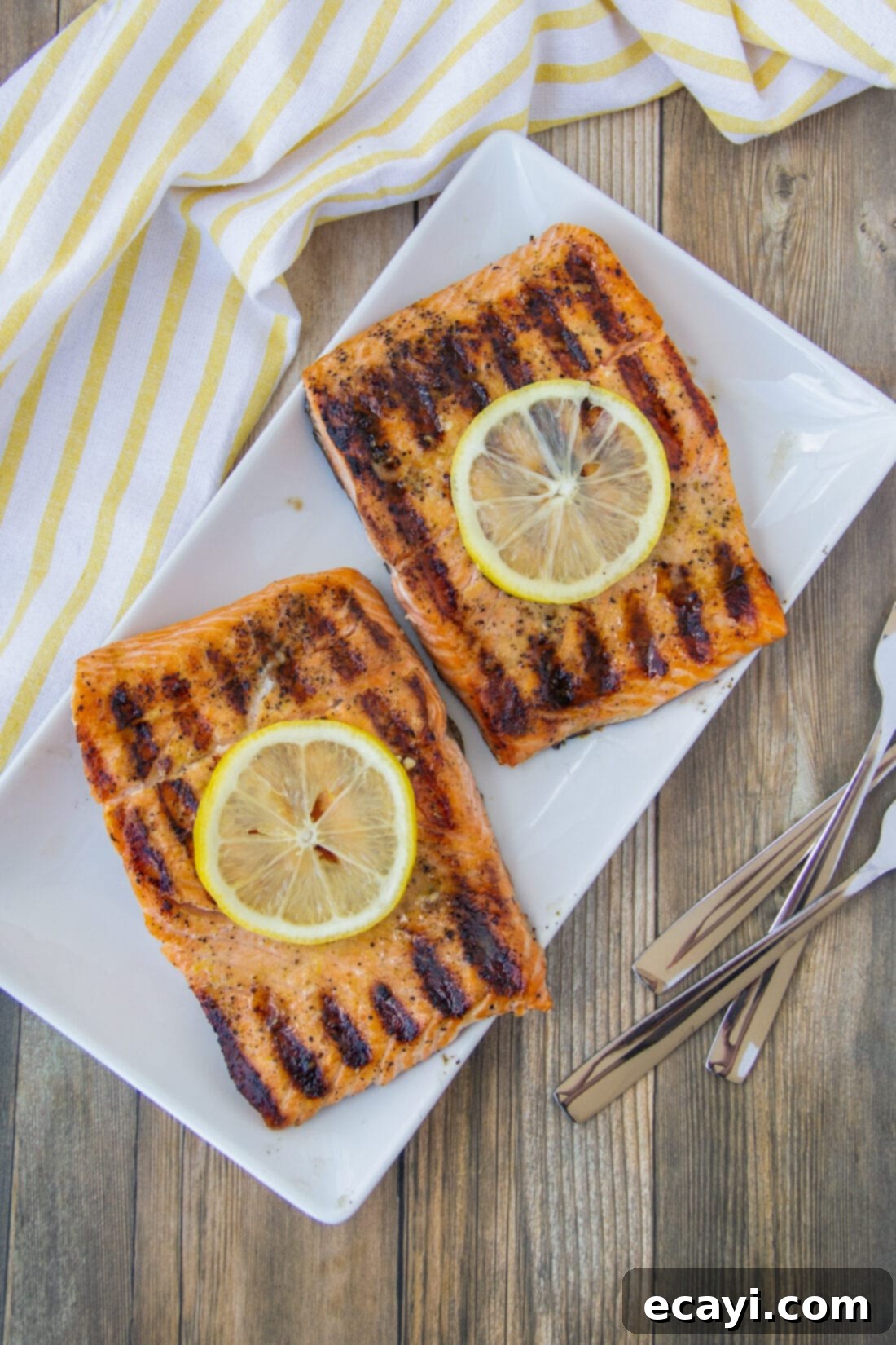 Lemony Salmon 3 Two perfectly grilled lemon garlic salmon fillets presented on a elegant platter, ready to be served.