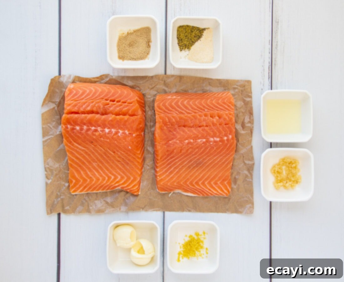 Lemony Salmon 4 All ingredients for the lemon garlic salmon recipe laid out on a kitchen counter: salmon fillets, lemons, butter, garlic, brown sugar, and seasonings.