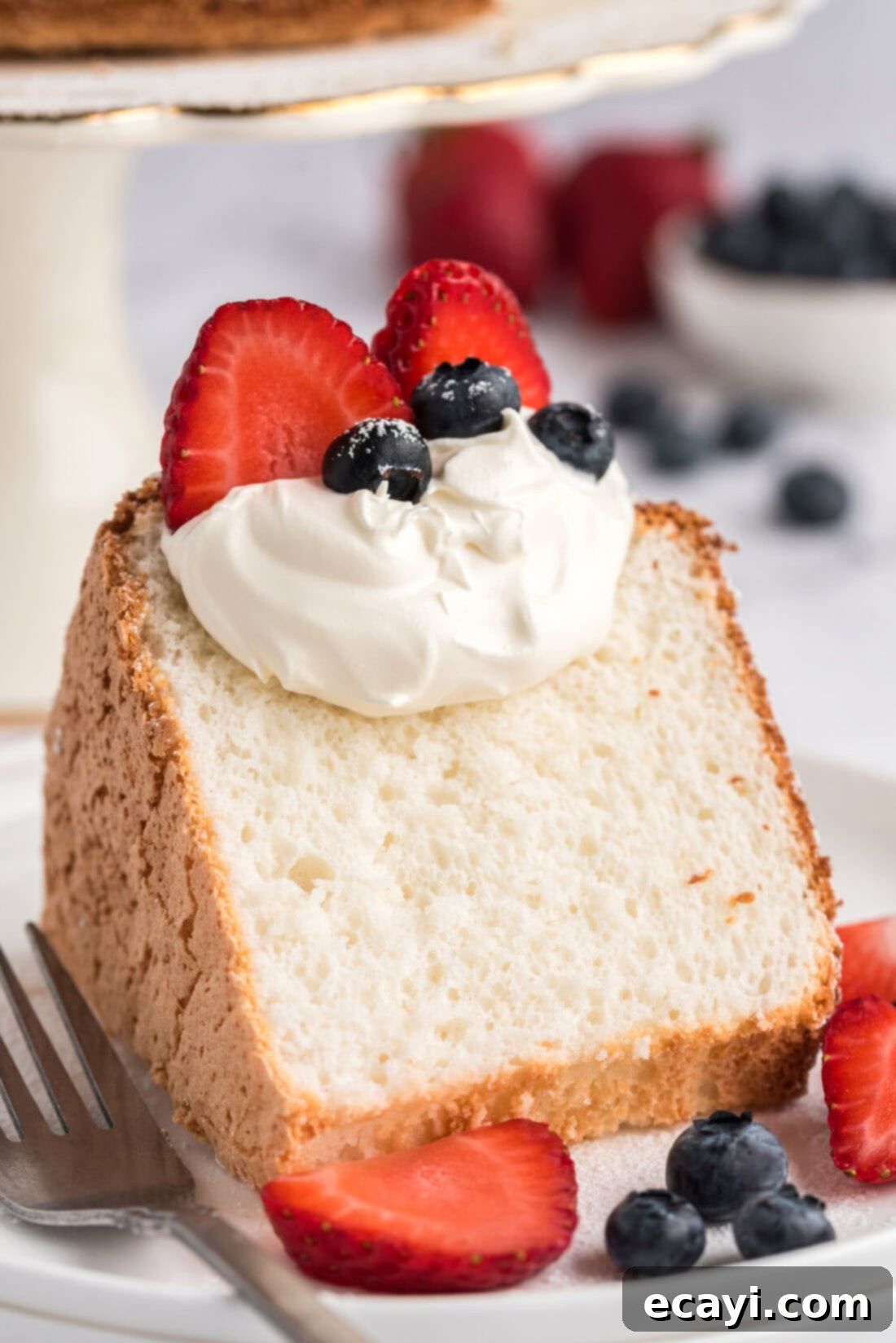 Heavenly Homemade Angel Food Cake 2 Slice of Angel Food Cake topped with whipped cream and berries
