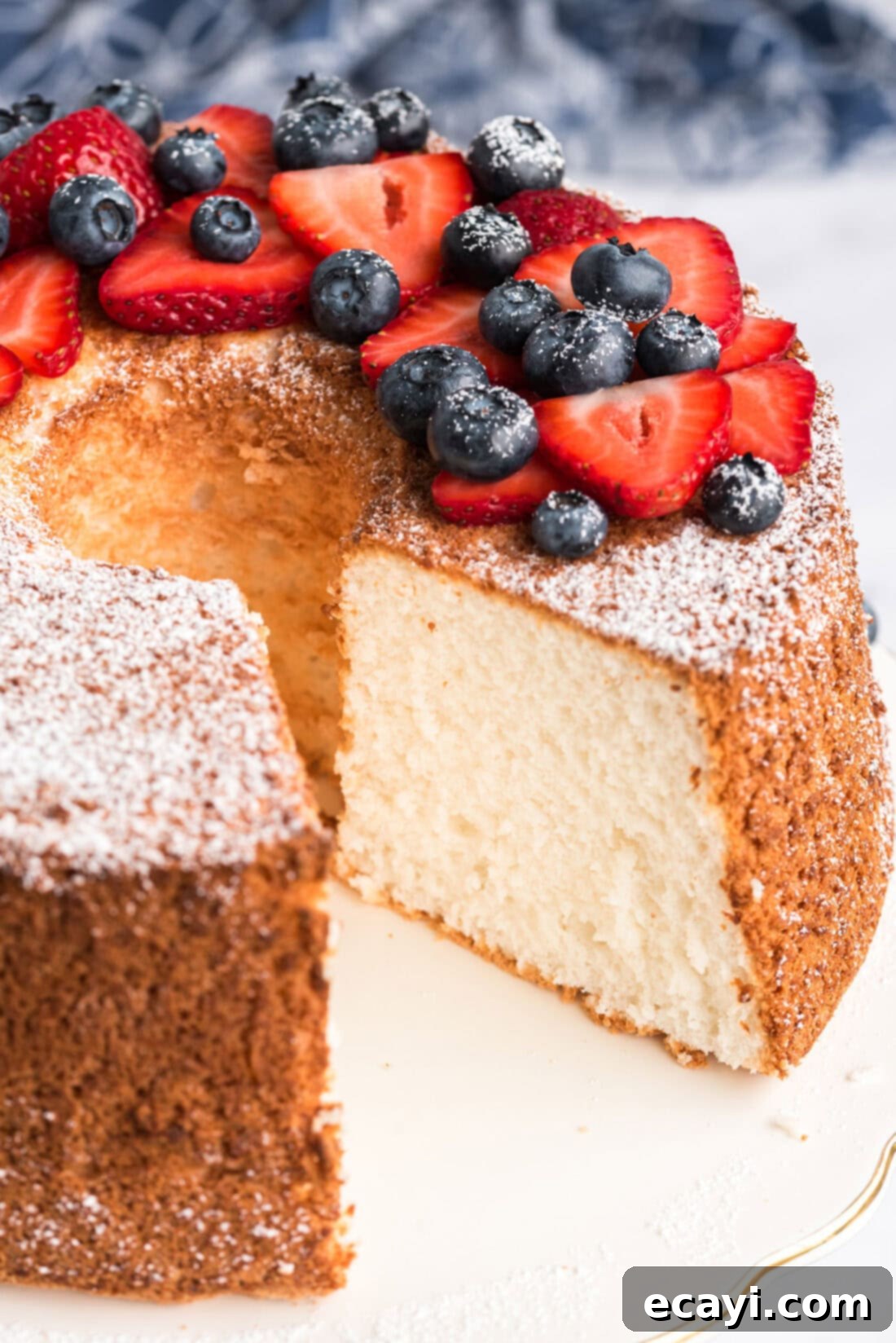 Heavenly Homemade Angel Food Cake 3 Whole Angel Food Cake topped with powdered sugar and fresh berries with one slice removed