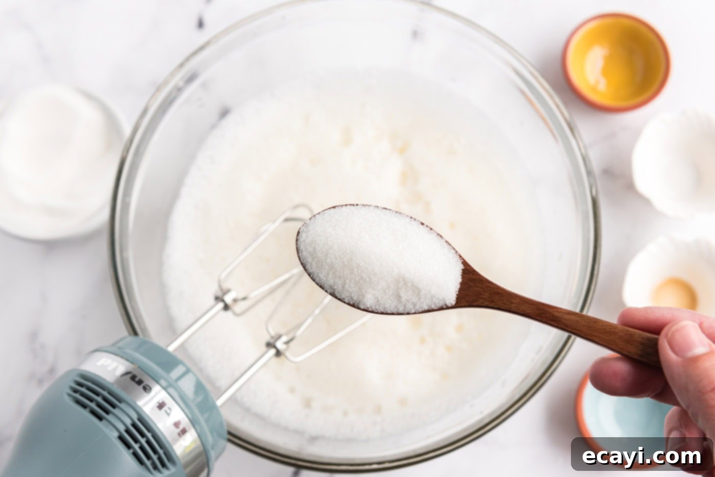Heavenly Homemade Angel Food Cake 8 Gradually spooning granulated sugar into the egg white mixture while beating with an electric mixer
