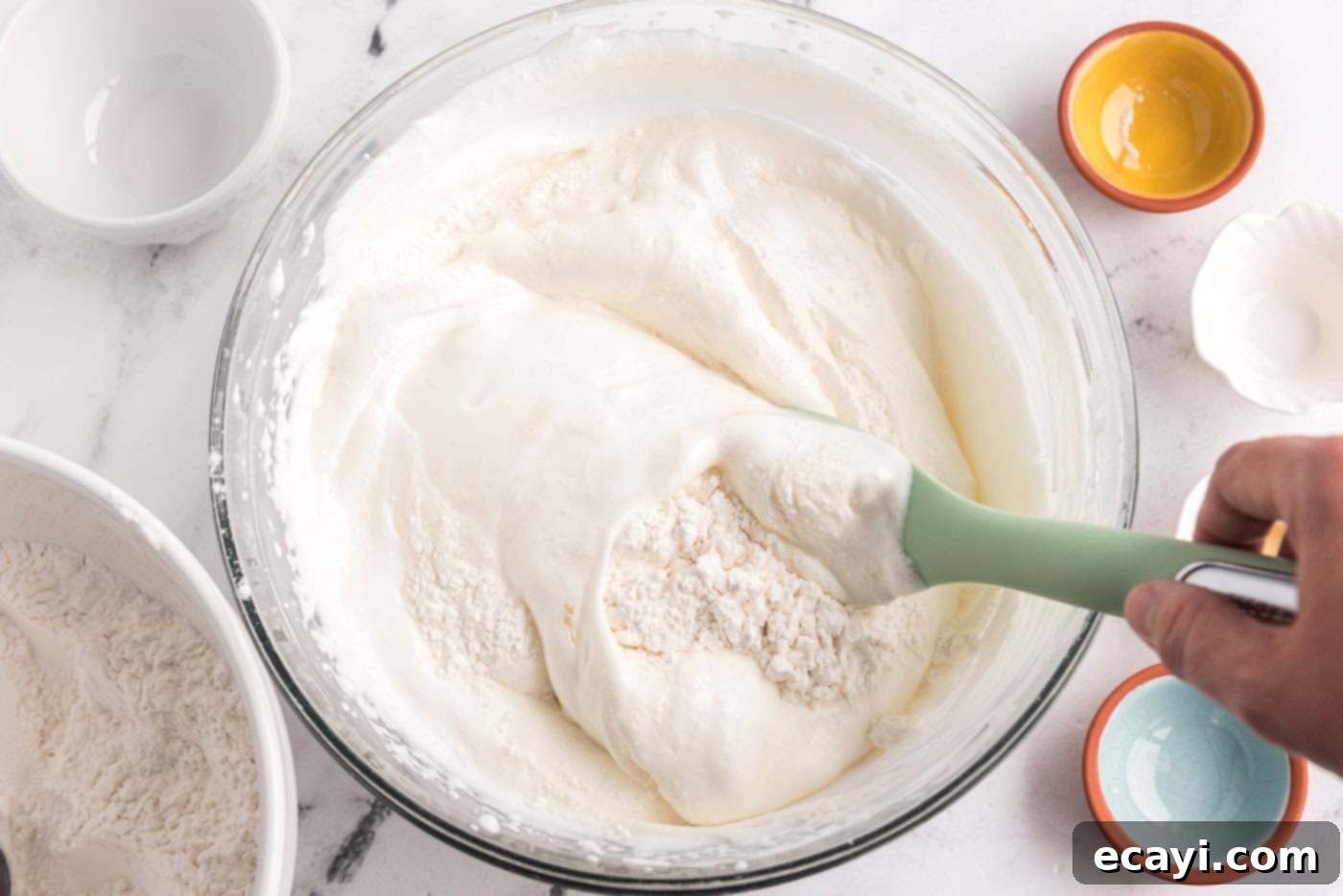Heavenly Homemade Angel Food Cake 9 Folding the flour mixture into the egg white meringue with a rubber spatula