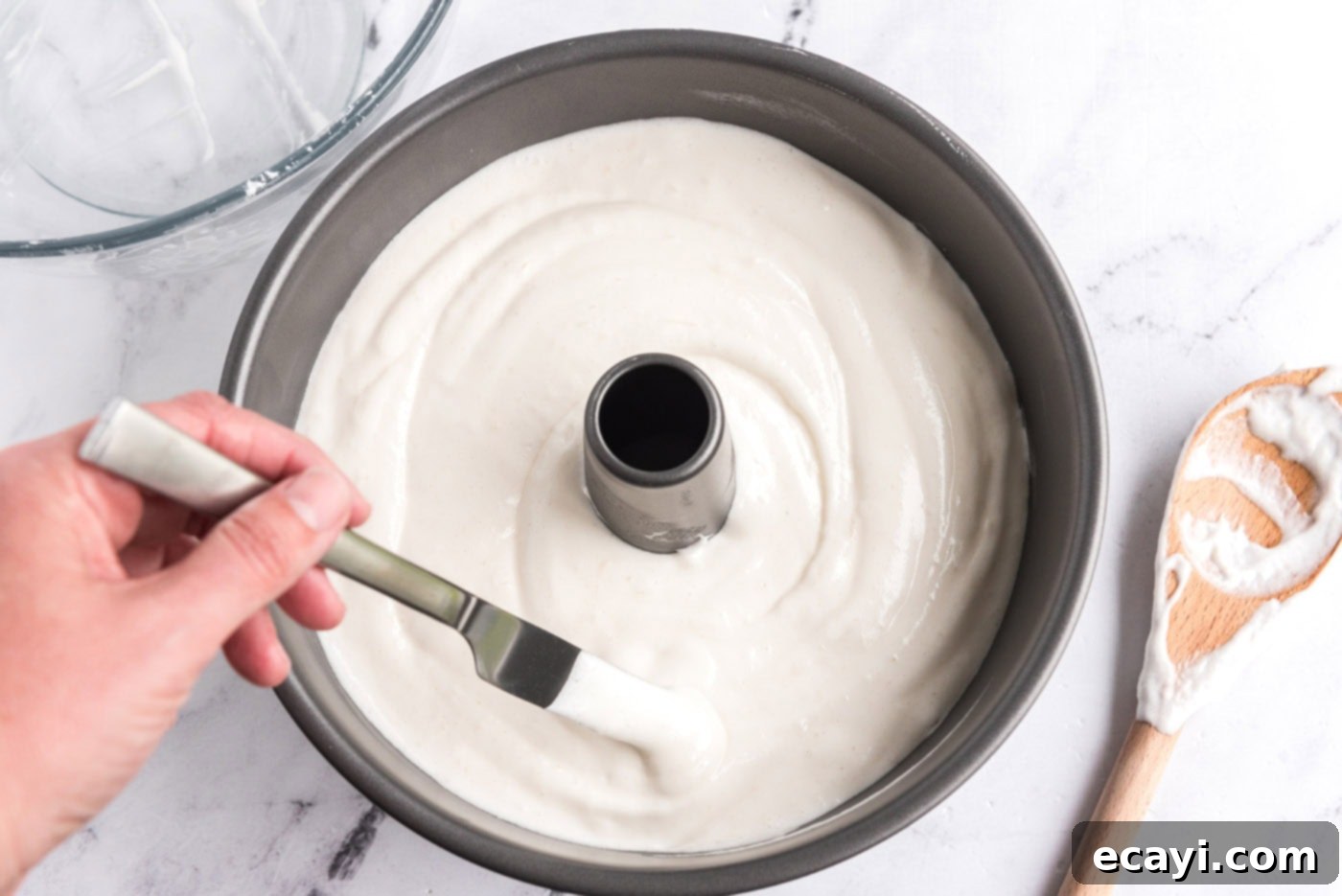 Heavenly Homemade Angel Food Cake 10 Removing air pockets from angel food cake batter in a tube pan using a butter knife