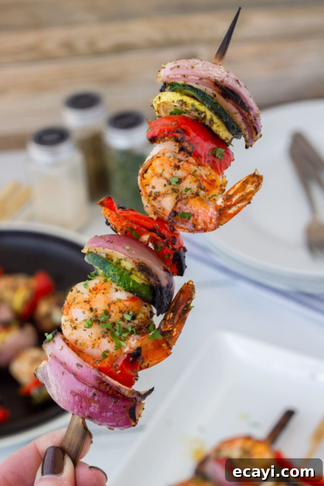 Garlic Herb Shrimp Skewers 12 holding a Shrimp Kabob