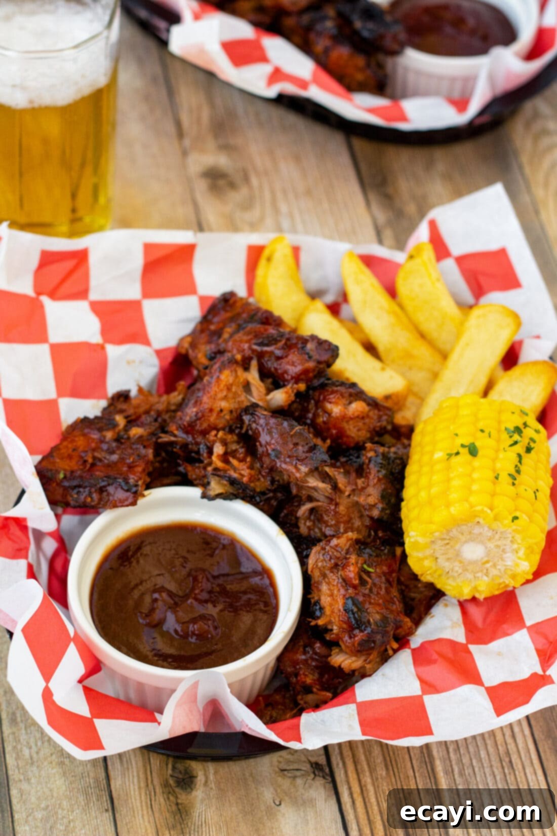 Smoked Rib Ends 3 Succulent rib tips piled high in a rustic basket, perfectly sauced and accompanied by fresh corn, showcasing their grilled char.