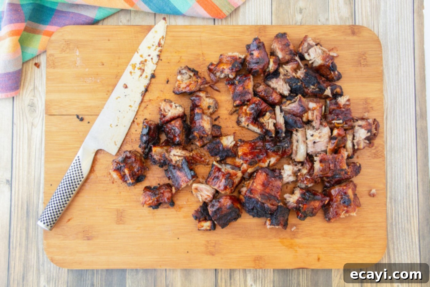 Smoked Rib Ends 7 Freshly chopped rib tips, coated in barbecue sauce, resting on a cutting board, ready to be served.