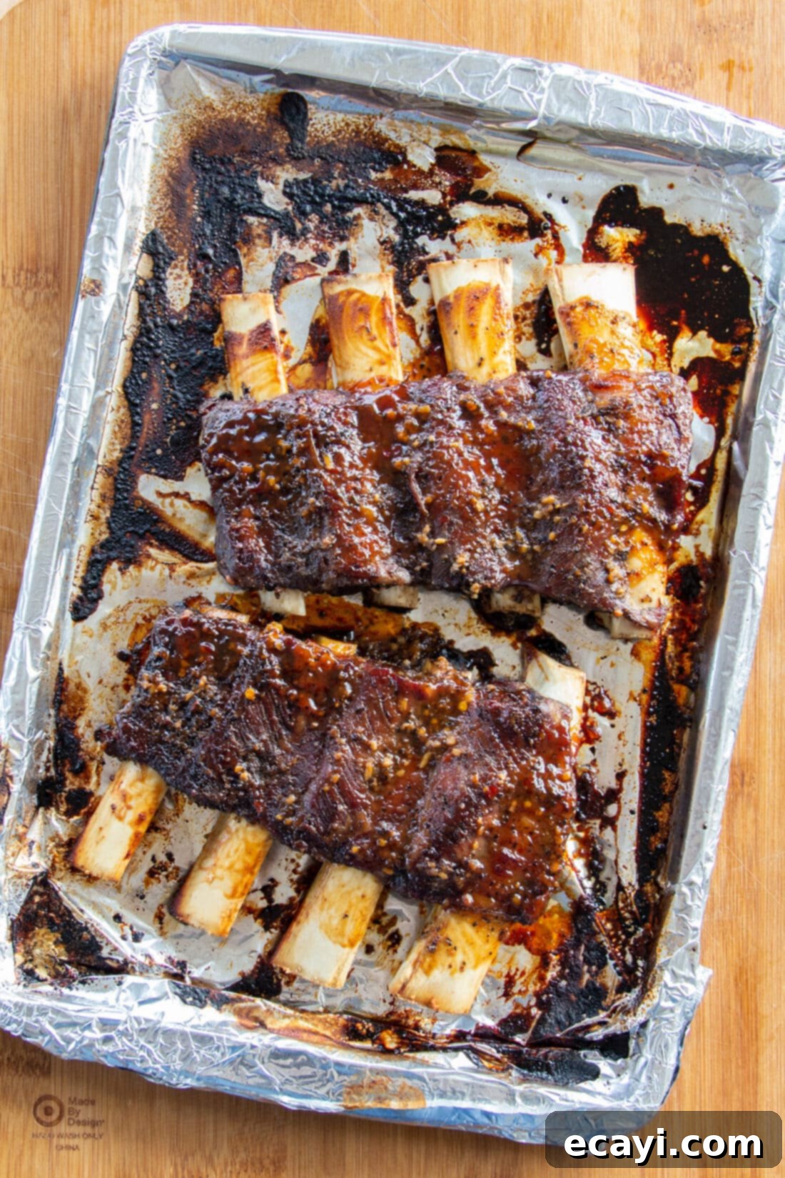 Fall-Off-The-Bone Beef Ribs 3 Beef Ribs on a pan that were made in the oven