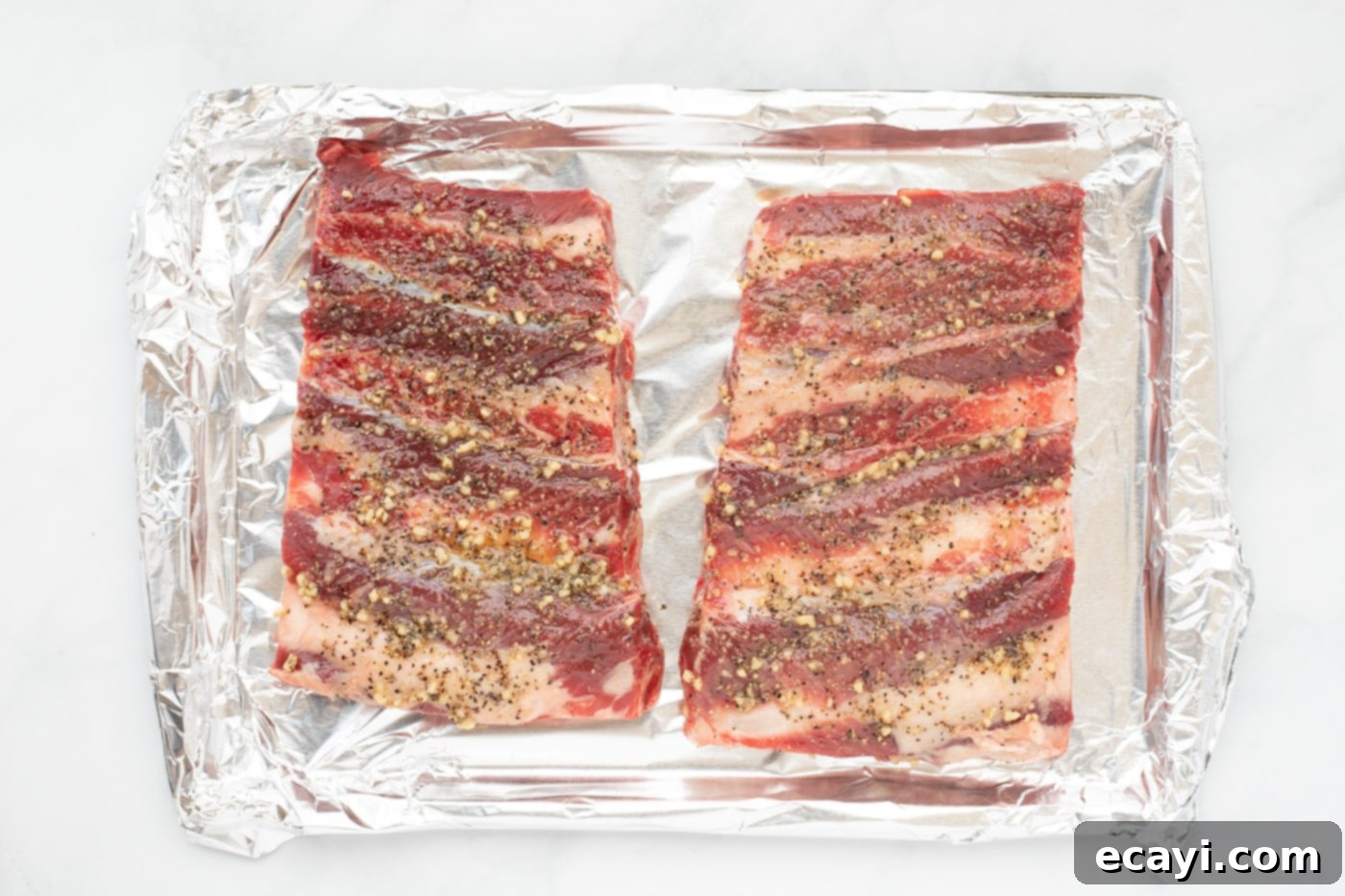 Fall-Off-The-Bone Beef Ribs 6 beef chuck riblets on a baking sheet
