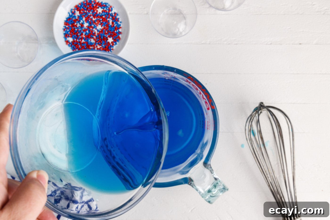 Star-Spangled Gelatin Shots 6 pouring alcohol into blue jello