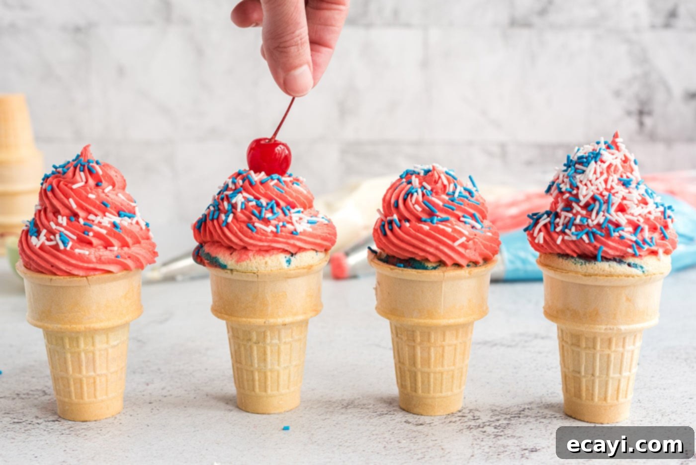 Patriotic Cone Cupcakes 13 Adding a maraschino cherry to a patriotic ice cream cone cupcake