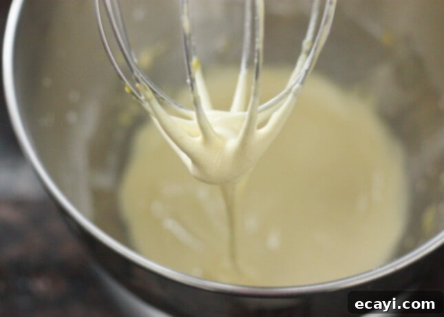 Chocolate Eclairs A Visual Step by Step Guide 12 Beating sugar, flour, cornstarch, and egg yolks for pastry cream until thick and pale yellow // FoodNouveau.com