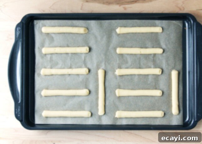 Chocolate Eclairs A Visual Step by Step Guide 22 Precisely piped choux paste logs, ready to be baked into éclairs // FoodNouveau.com