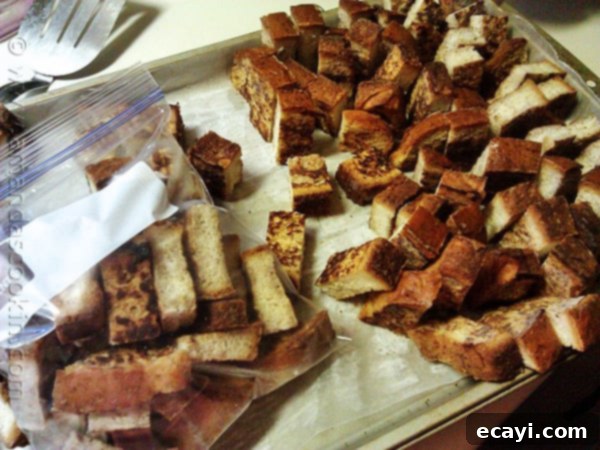 How to flash freeze French toast sticks A close up photo of homemade freezer French toast sticks on a cooling rack.