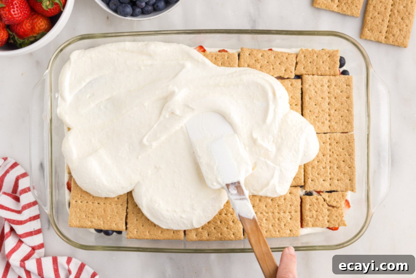 Berry Burst Chill Cake 15 spreading cream cheese mixture over graham crackers