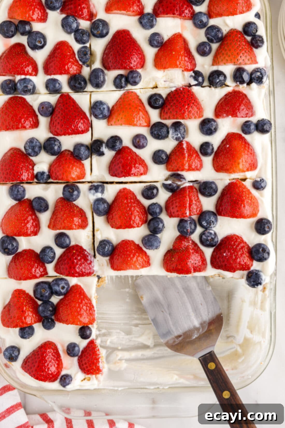Berry Burst Chill Cake 3 overhead of Mixed Berry Icebox Cake with slices removed and spatula in pan