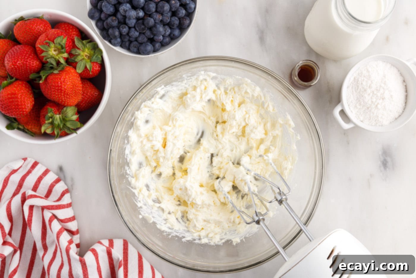 Berry Burst Chill Cake 5 cream cheese beaten in a bowl with a mixer