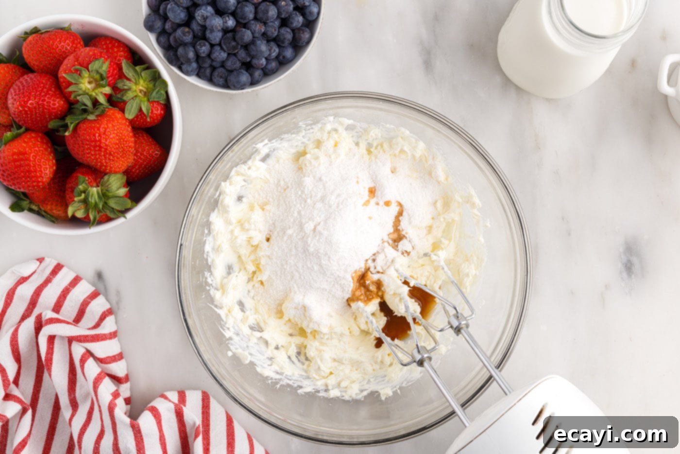 Berry Burst Chill Cake 6 cream cheese, pudding mix, milk, and vanilla mixed in a bowl