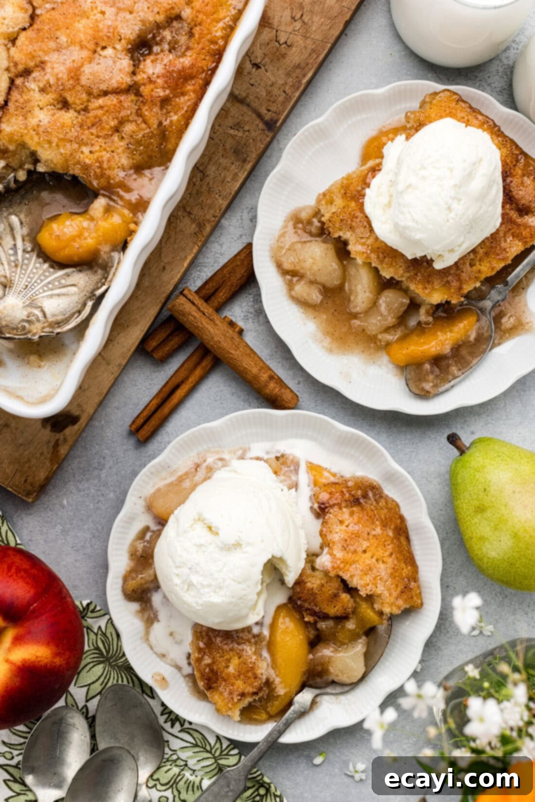Golden Pear Peach Cobbler 2 Two plates of Pear-Peach Cobbler topped with ice cream