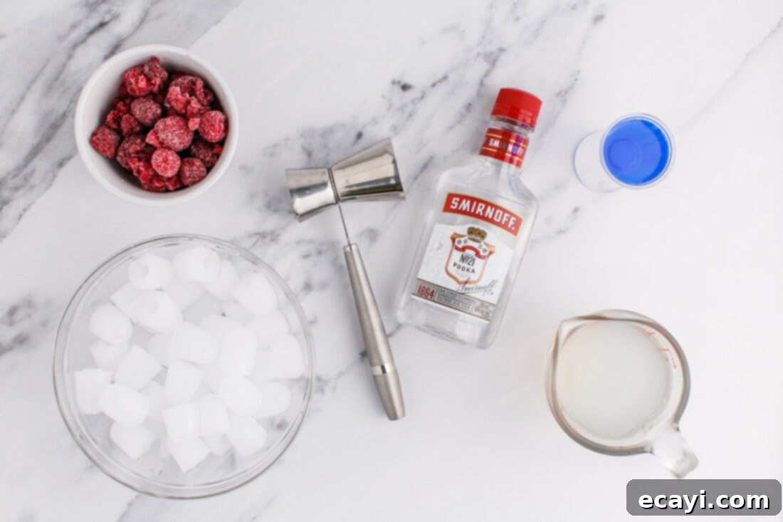 Red White & Boozy Freeze 4 A flat lay of the ingredients for Patriotic Vodka Lemonade Slushie, including bags of frozen raspberries, bottles of vodka and blue curacao, and fresh lemons, arranged on a rustic wooden surface.