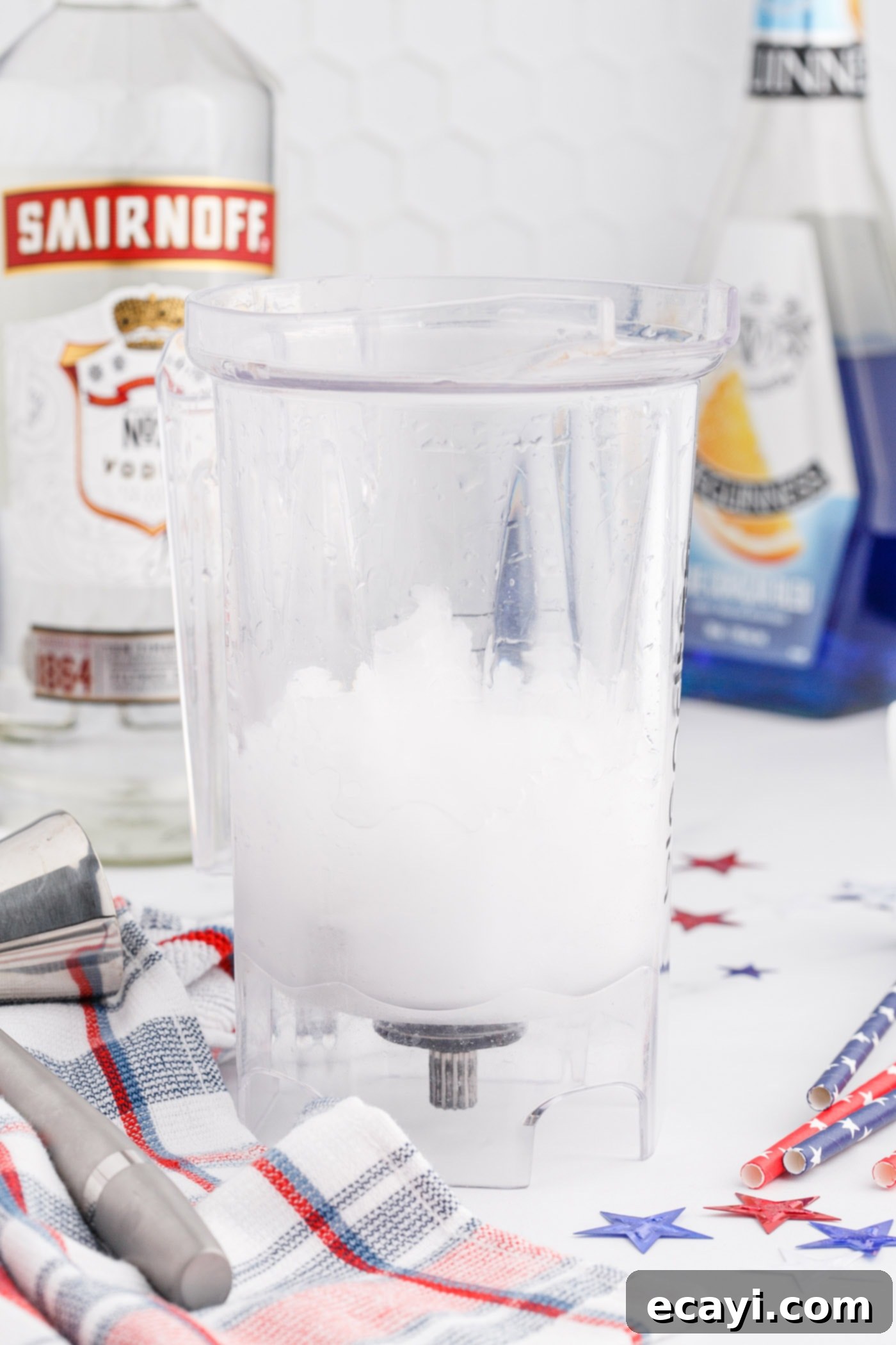 Red White & Boozy Freeze 7 The white layer of vodka lemonade slush being blended to a smooth, thick consistency in a blender.
