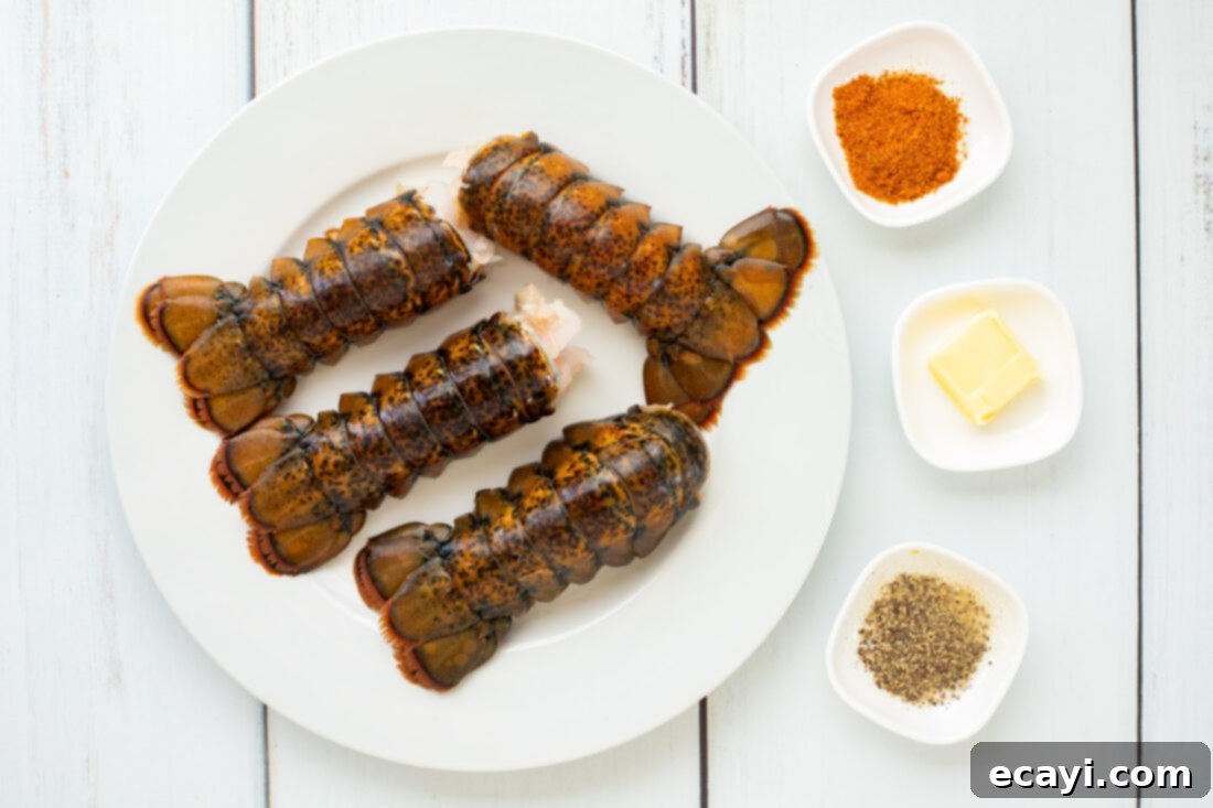 Succulent Steamed Lobster Tail 4 Close-up of fresh lobster tails, butter, Old Bay seasoning, and black pepper – the simple ingredients for a delicious steamed lobster.