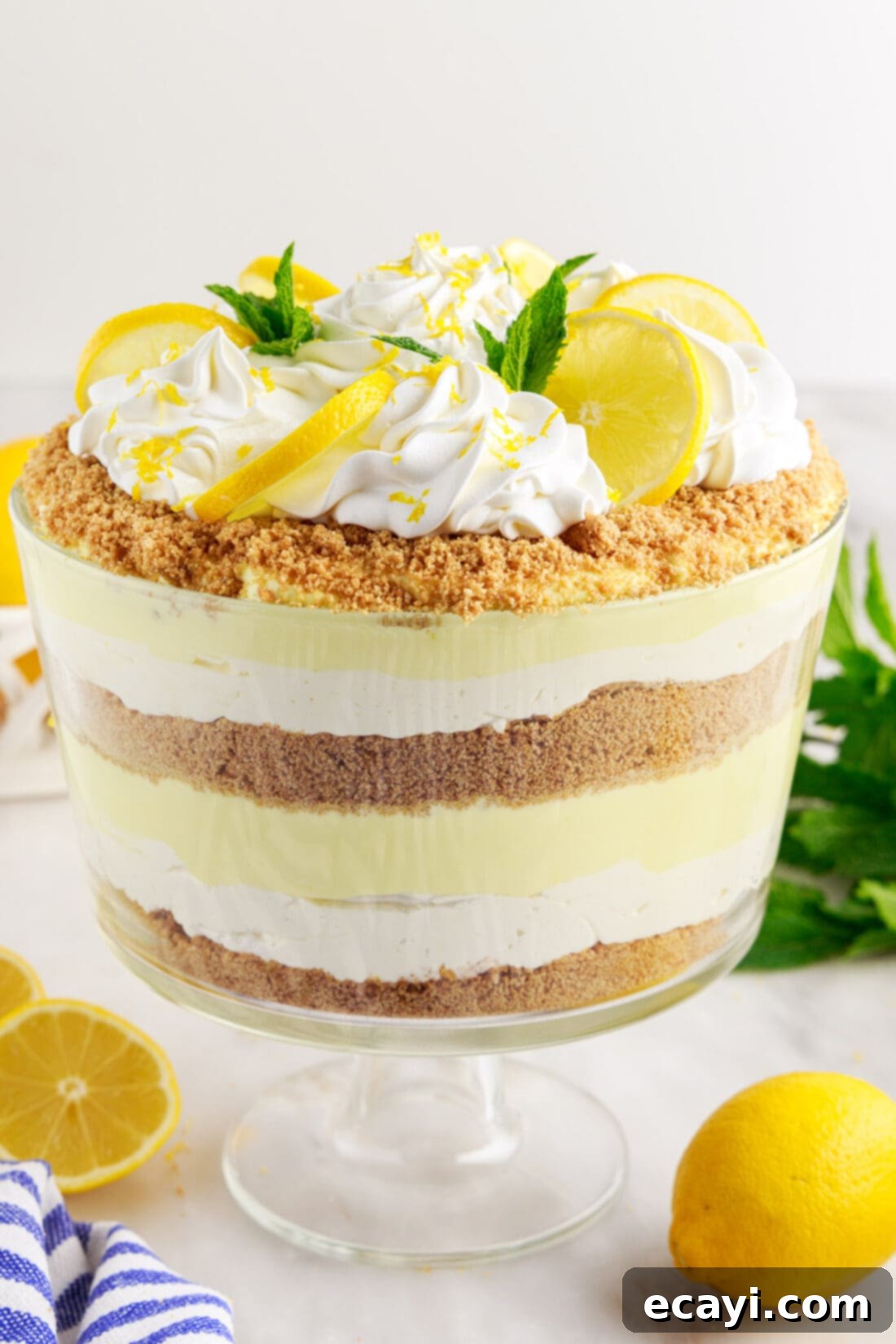 Golden Lemon Indulgence 2 Beautiful seven-layer Lemon Lush Trifle with mint garnish, perfect for any occasion.