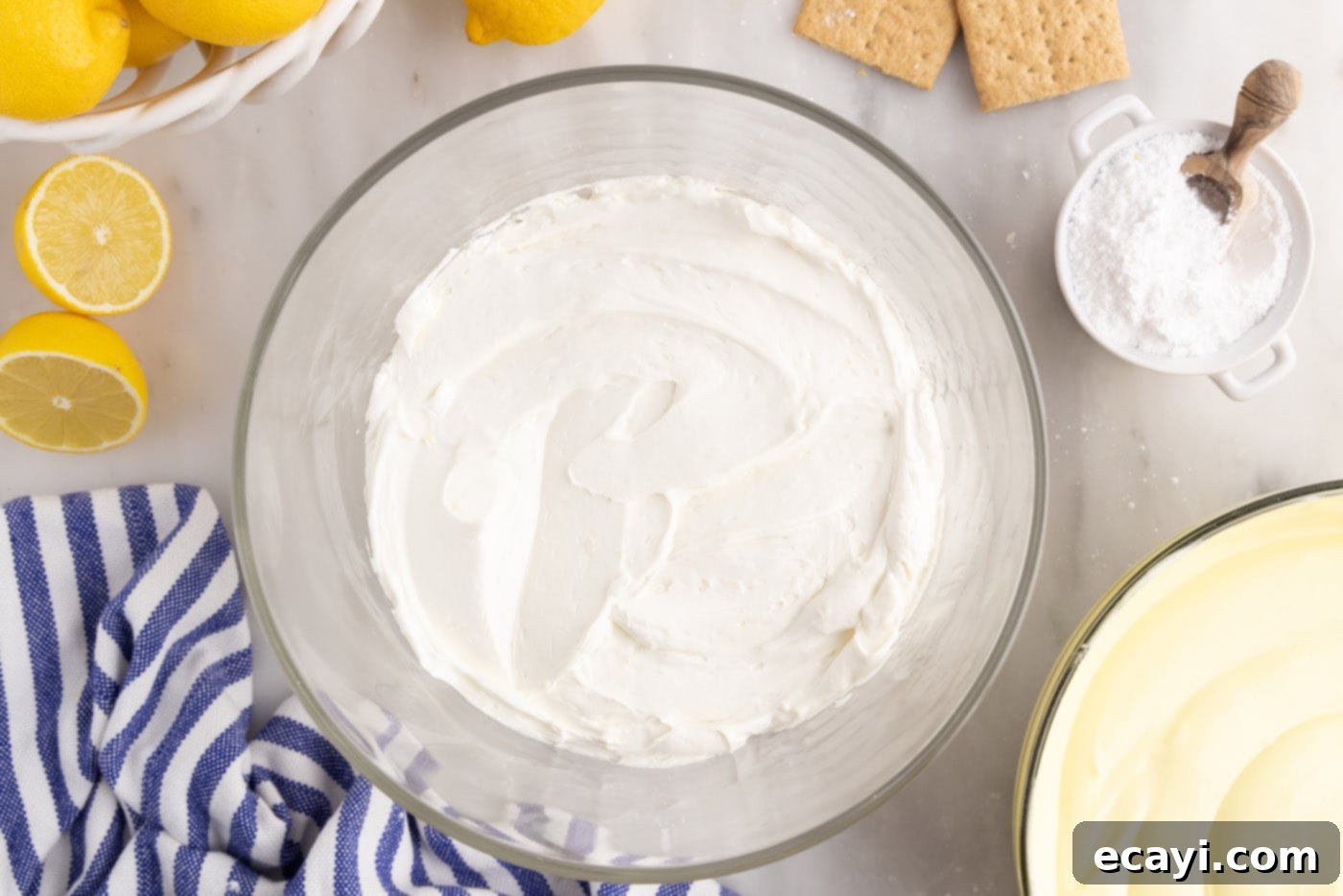 Golden Lemon Indulgence 13 Layer of cream cheese mixture spread over graham cracker crumbs in a trifle dish.