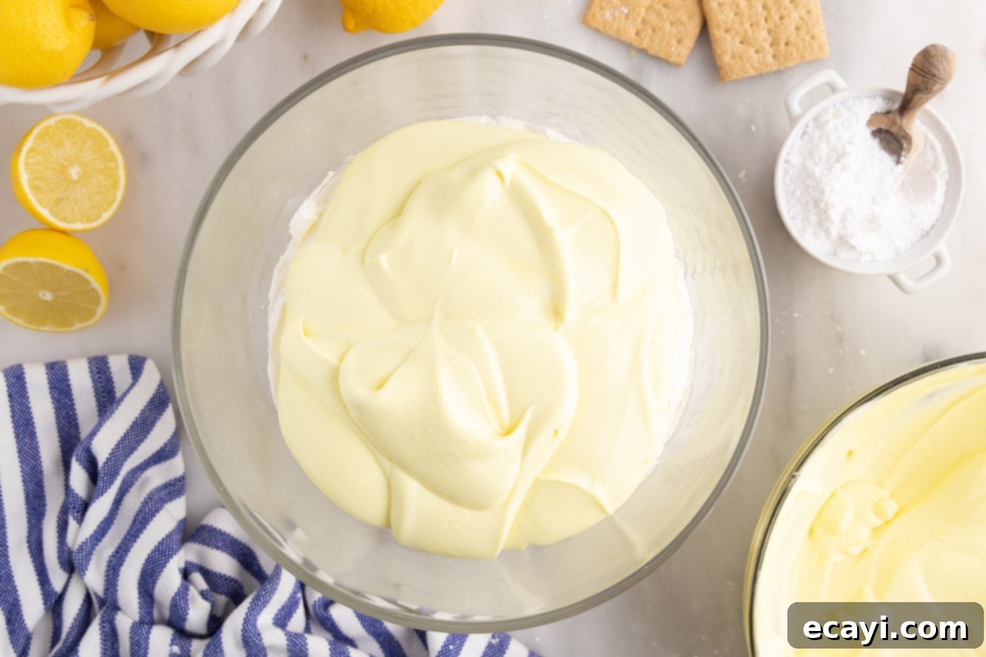 Golden Lemon Indulgence 14 Layer of lemon pudding mixture added on top of the cream cheese in a trifle bowl.