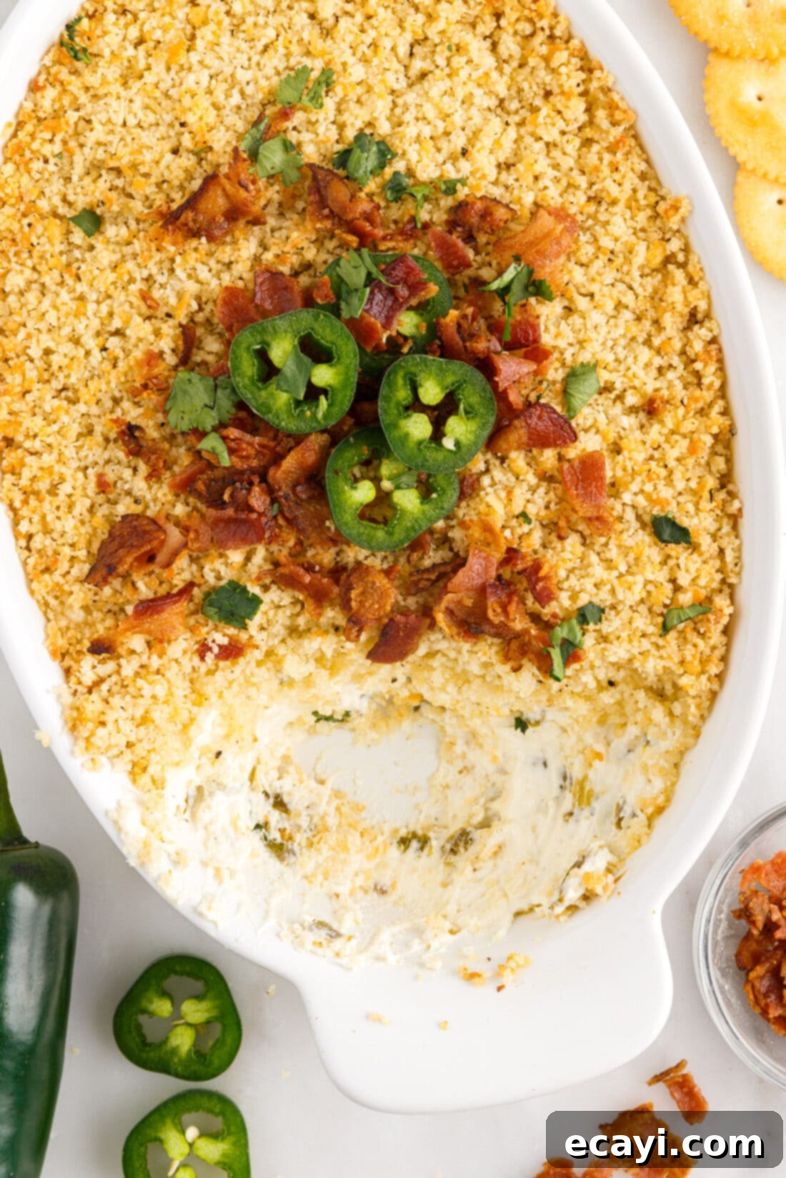 Zesty Jalapeno Delight Dip 3 Jalapeno Popper Dip in a dish with some removed