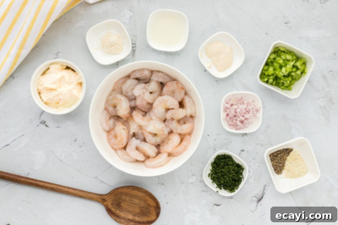 Zesty Shrimp Salad 4 All ingredients laid out for making Shrimp Salad, including uncooked shrimp, fresh dill, celery, shallots, lemon, and dressing components