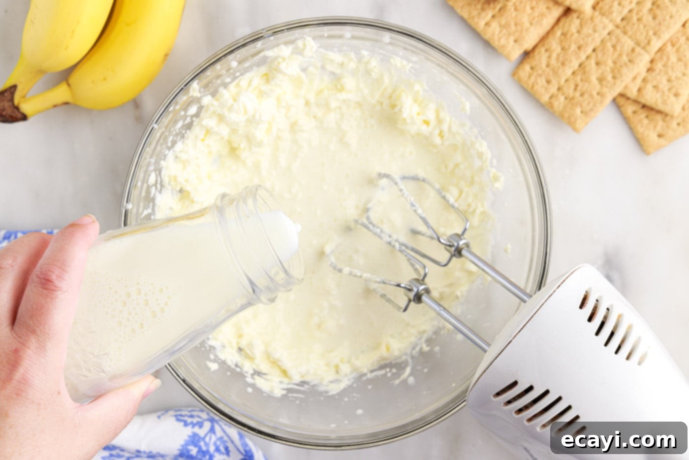 No-Bake Banana Cream Delight 5 pouring milk into cream cheese mixture