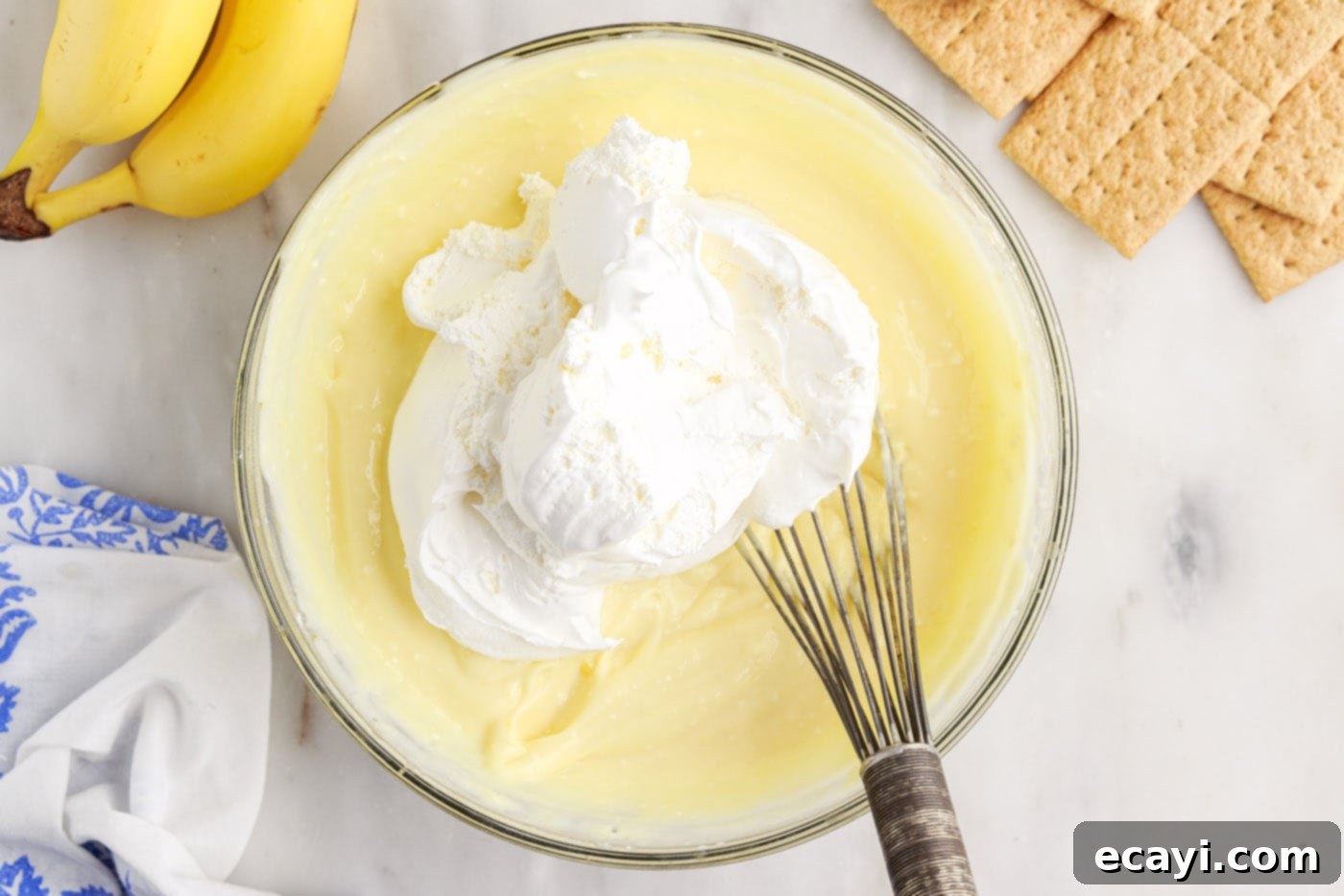 No-Bake Banana Cream Delight 7 folding cool whip into banana cream pudding mixture