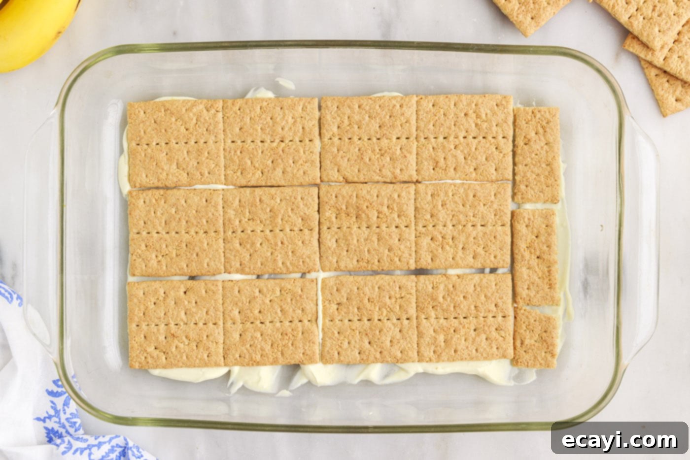 No-Bake Banana Cream Delight 10 graham crackers on top of pudding mixture in a baking dish