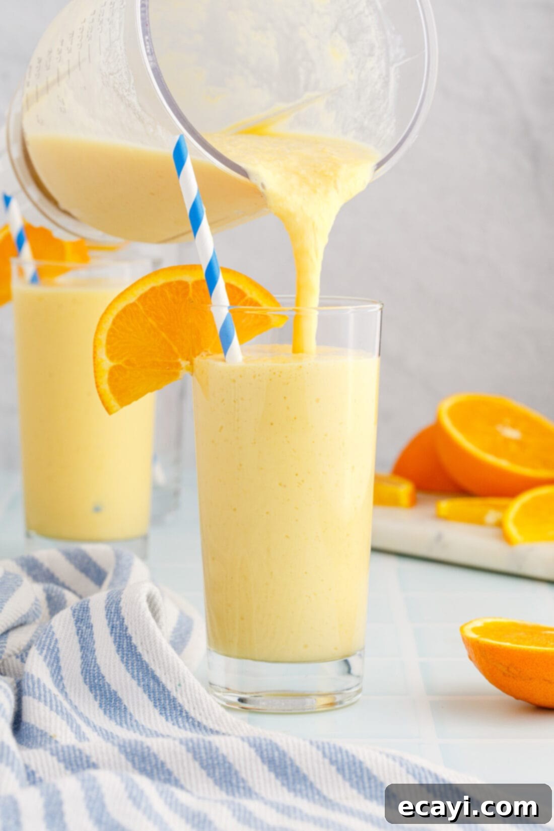 Orange Julius 2 pouring an Orange Julius from a blender into a tall glass