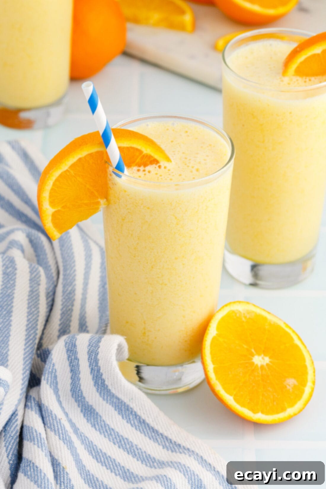 Orange Julius 3 Orange Julius with straw and orange slice garnish