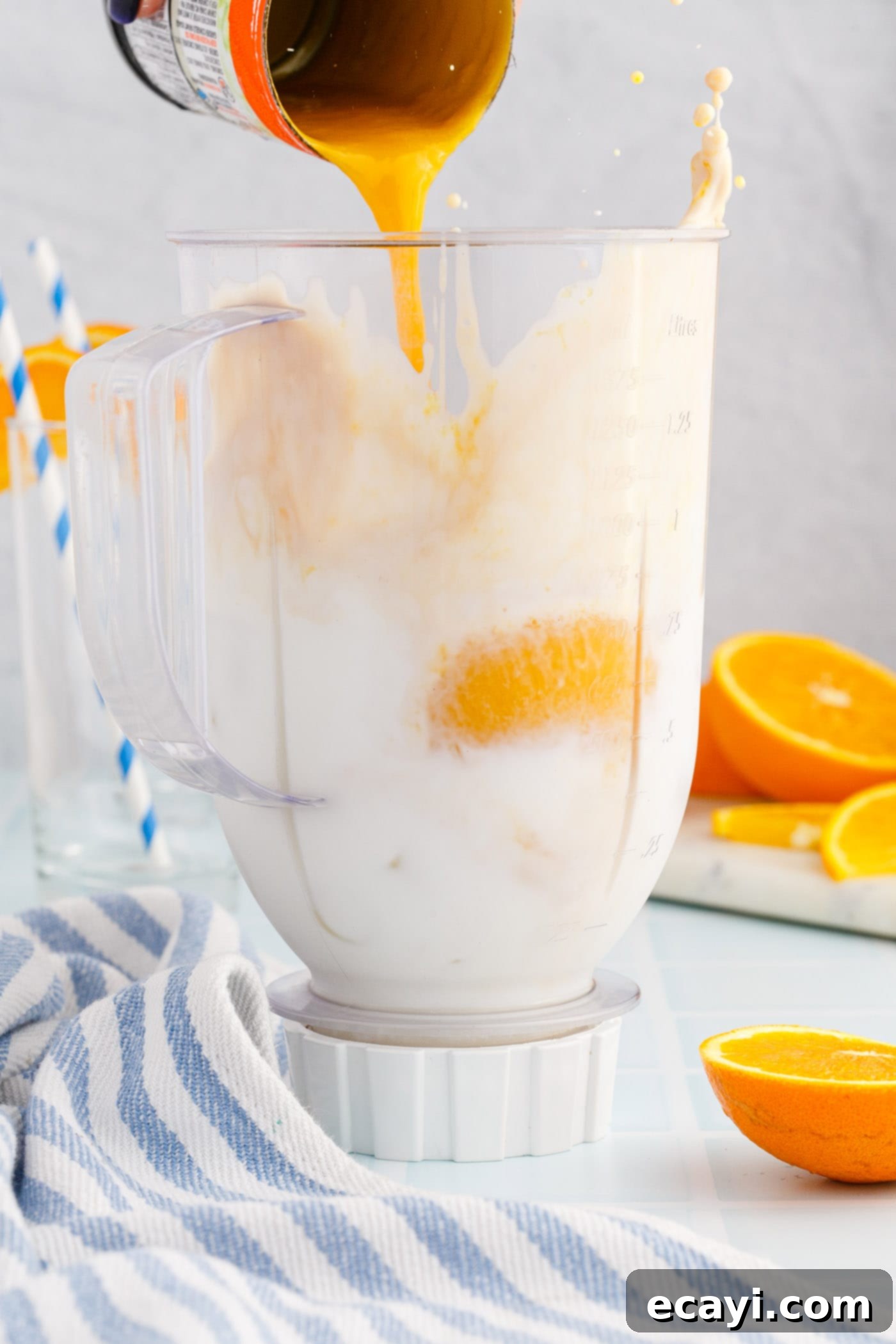 Orange Julius 5 pouring orange julius ingredients into a blender