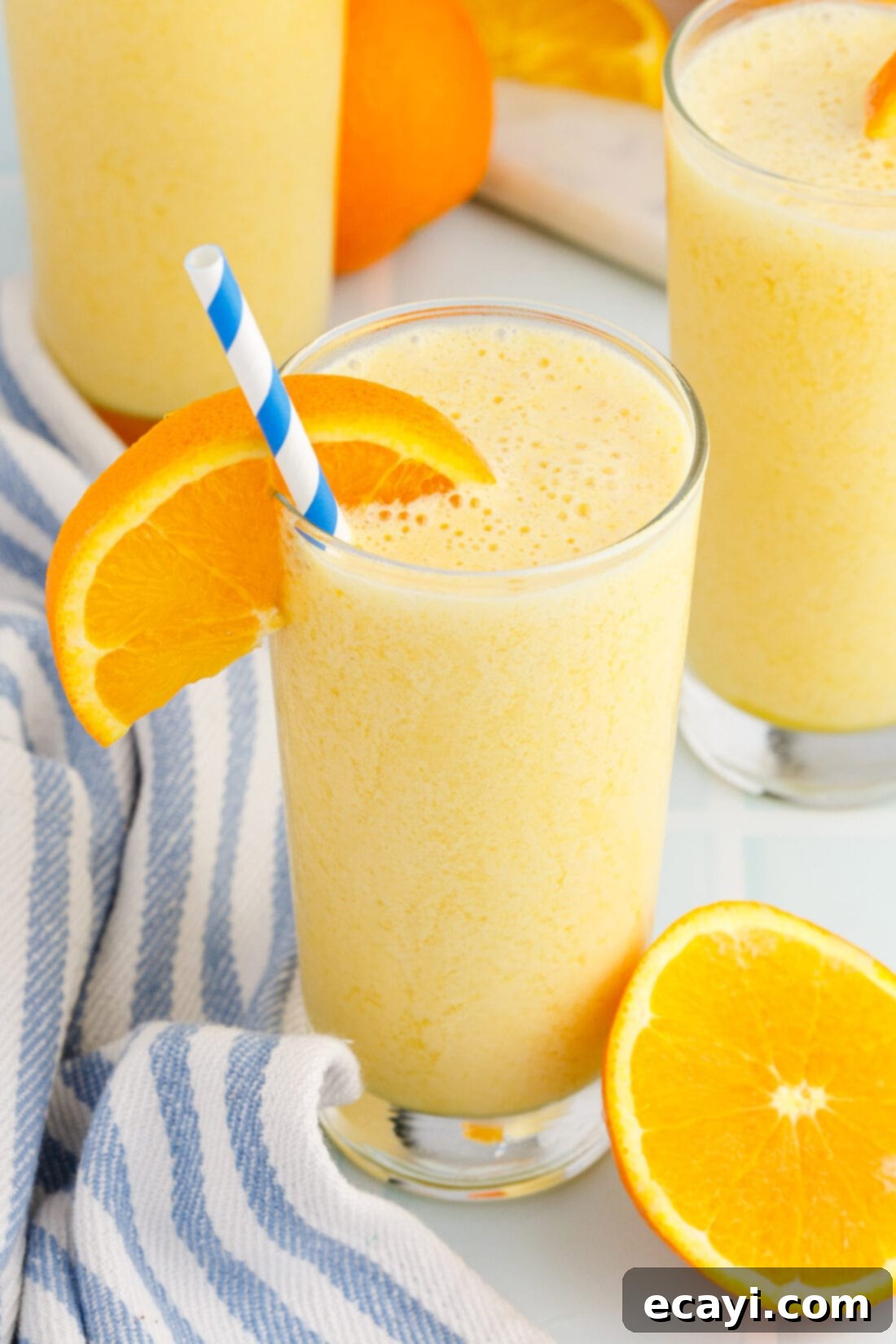 Orange Julius 7 glass of Orange Julius with straw and orange wedge