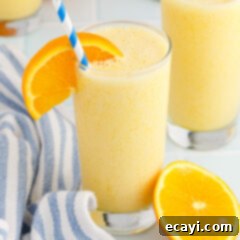 Orange Julius 8 A glass of homemade Orange Julius, garnished with an orange slice and a straw.