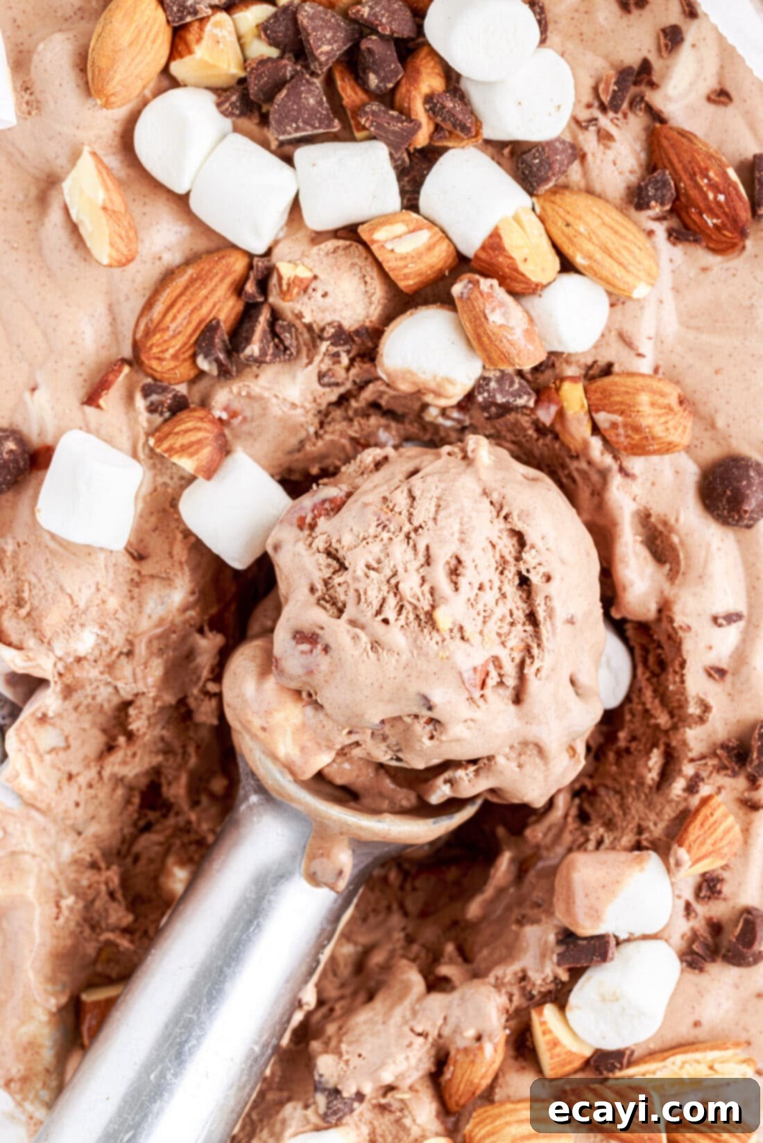 The Ultimate Rocky Road 2 scooping out some Rocky Road Ice Cream, showcasing its creamy texture and abundant mix-ins