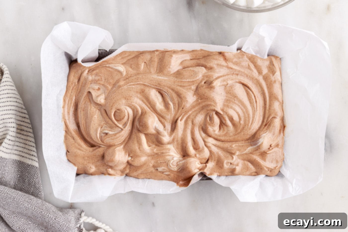 The Ultimate Rocky Road 11 rocky road ice cream mixture swirled into a loaf pan lined with parchment paper
