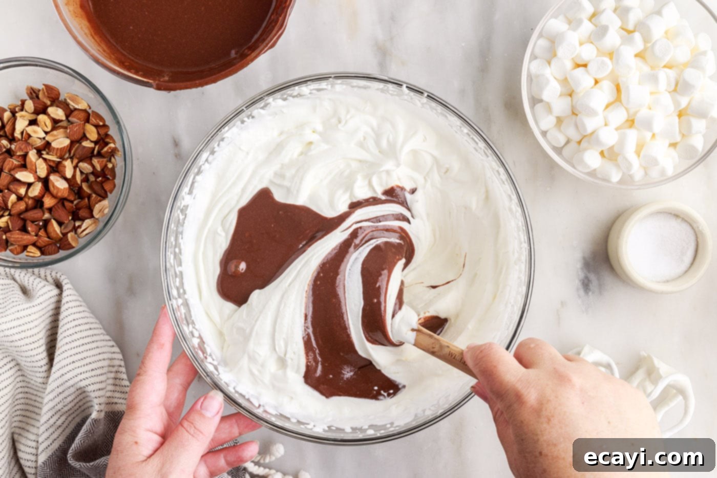 The Ultimate Rocky Road 9 folding chocolate mixture into whipped cream using a spatula