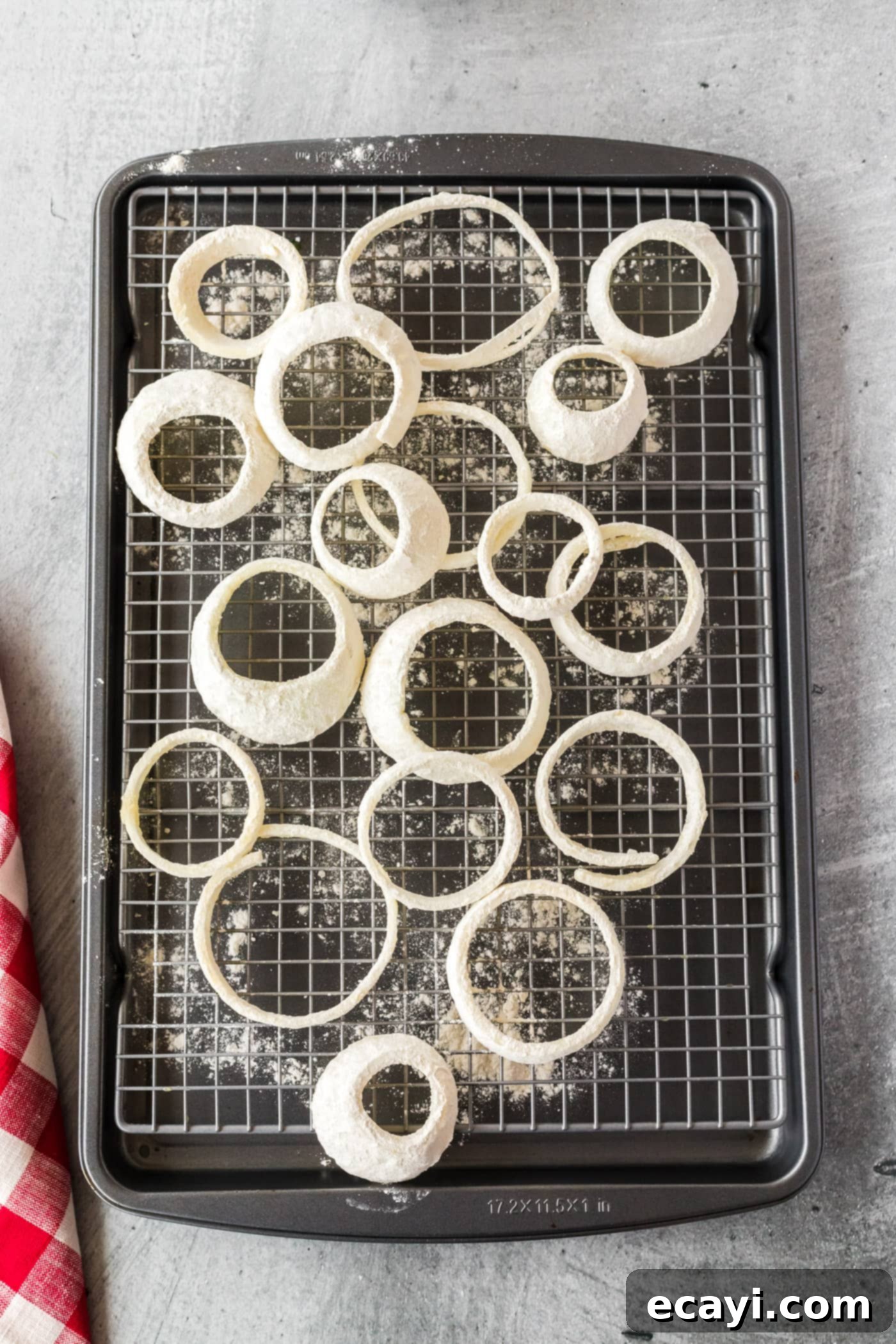 Golden Onion Crisps 6 Onion rings being coated in a mixture of flour and baking powder