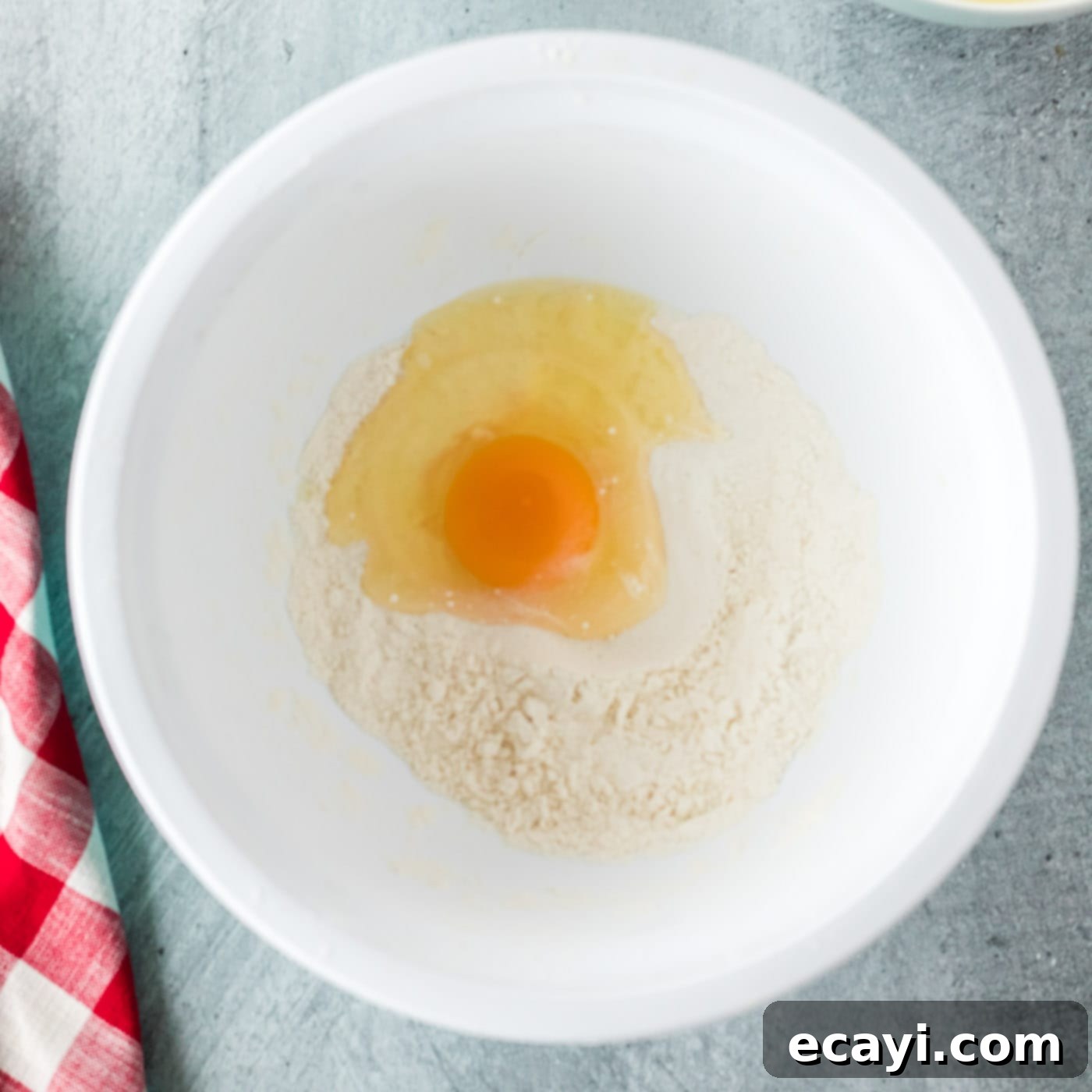 Golden Onion Crisps 7 Egg and milk being mixed into the flour and baking powder to create a smooth batter
