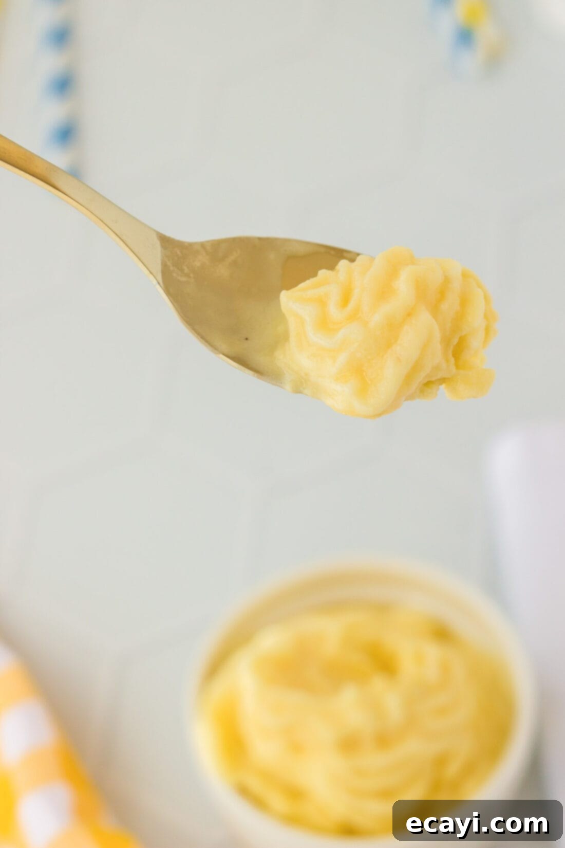 Pineapple Paradise Swirl 7 A single spoonful of creamy homemade Dole Whip, showcasing its smooth texture and readiness to be savored.