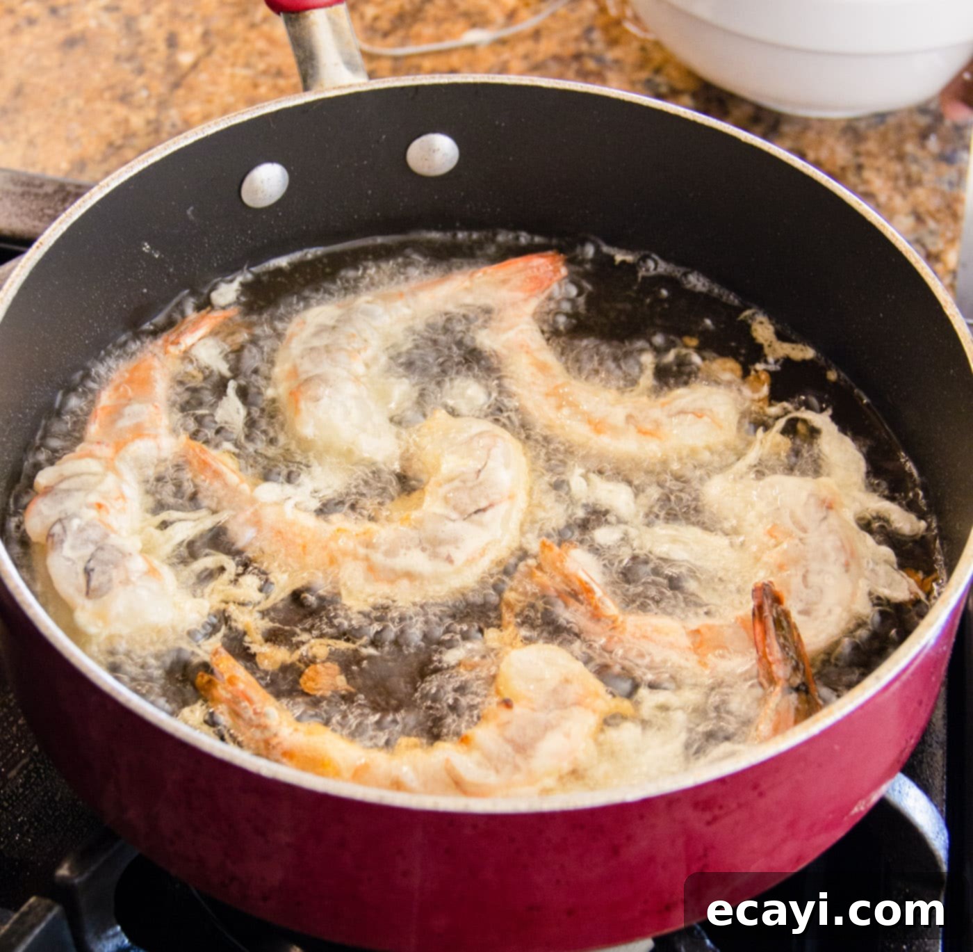 Golden Crispy Shrimp 9 Golden brown crispy shrimp sizzling beautifully in a hot skillet, halfway through cooking, showing perfect crispiness.