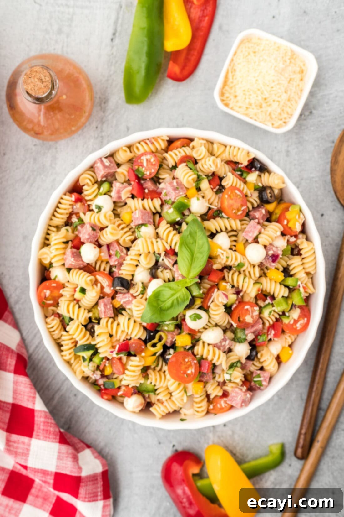 Zesty Italian Pasta Salad 2 Large bowl filled with colorful Italian Pasta Salad, showcasing pasta, vegetables, salami, and mozzarella.
