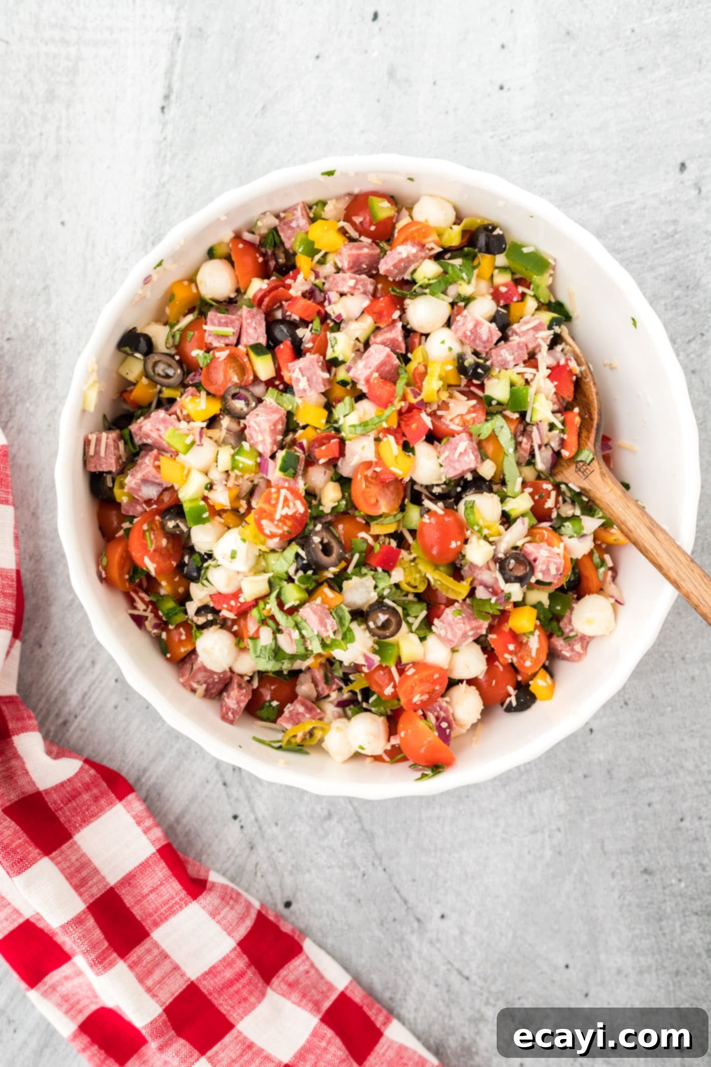 Zesty Italian Pasta Salad 6 Chopped vegetables, meats, and cheeses for Italian pasta salad mixed together in a large bowl.